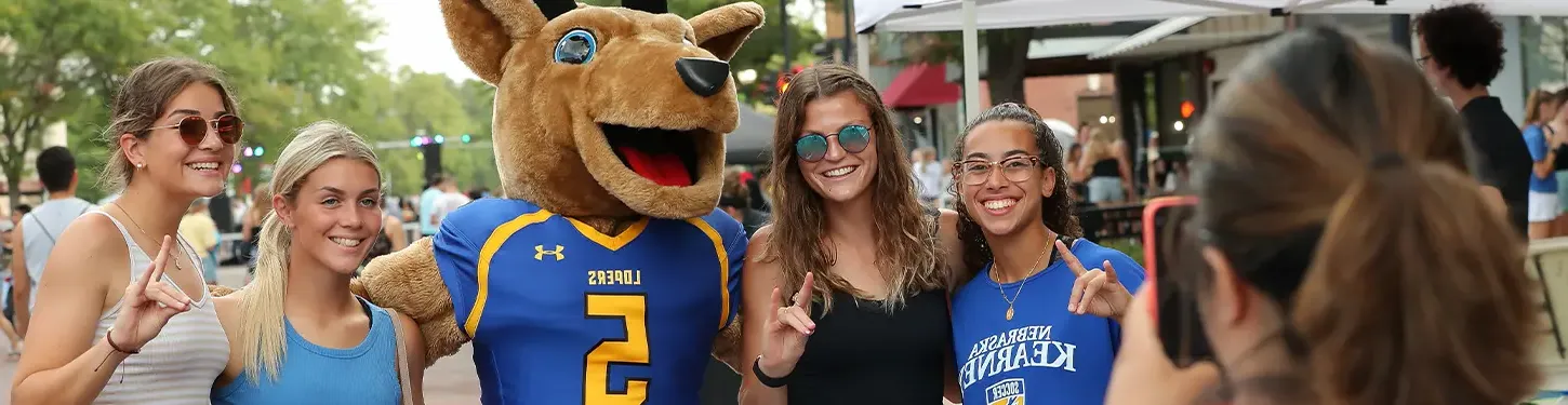 Students pose with Louie the Loper at the Destination Downtown event